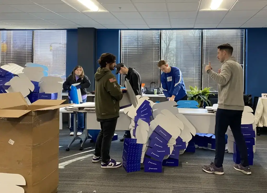 RCS and Marian University Volunteers packaging ETV boxes
